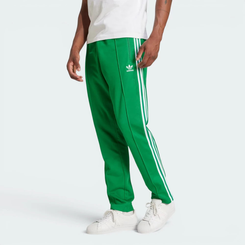 Highlights the high-velocity sweep of the continuous white 3-Stripes running flawlessly down the professional, deep emerald depth of the Green leg panels. Main image
