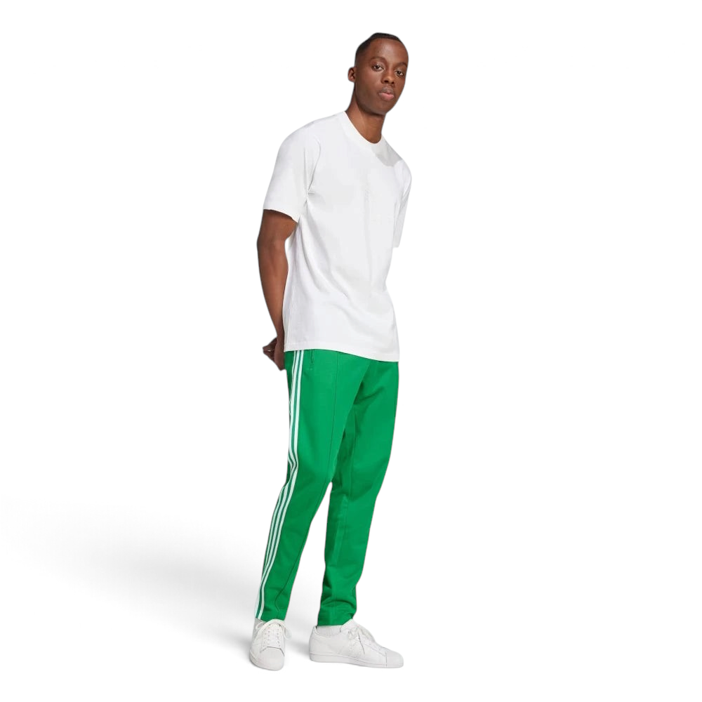 Emphasising the sharp visual contrast of the premium embroidered white Trefoil logo standing proud against the rich green fabric backdrop.