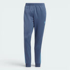 Highlights the high-velocity sweep of the Preloved Ink navy 3-Stripes running flawlessly down the professional, electric depth of the Semi Blue Burst leg panels.