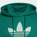 Close-up of the Trefoil logo on the chest, highlighting the crisp screen-print quality against the green fabric.