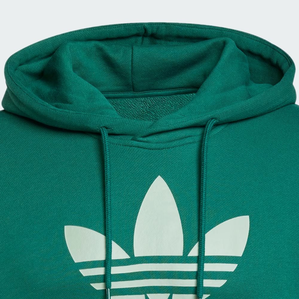 Close-up of the Trefoil logo on the chest, highlighting the crisp screen-print quality against the green fabric.