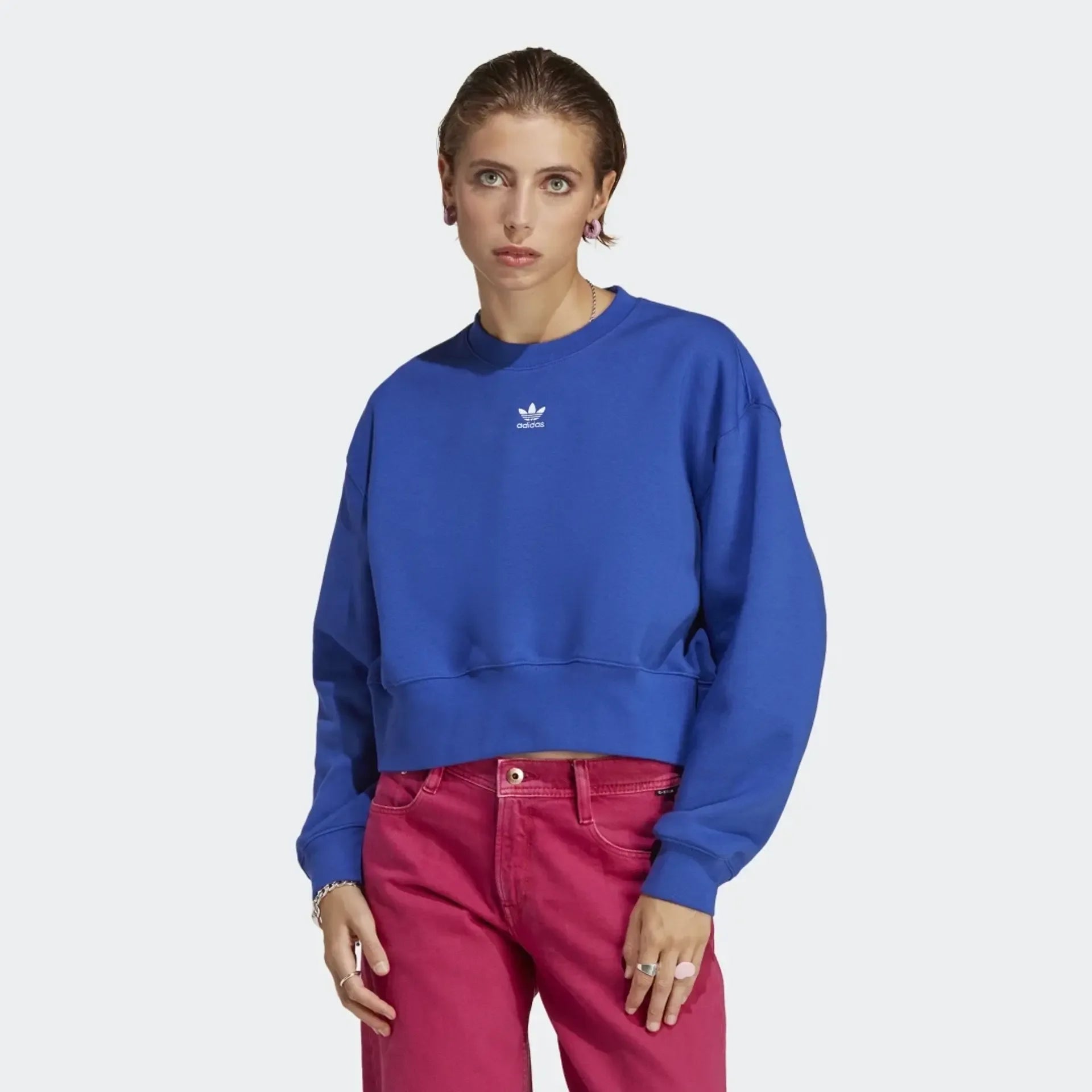 Adidas Adicolor Essentials Fleece Crew Sweatshirt Women's in blue, front view showing the ribbed crewneck, cuffs, and hem, and small embroidered Trefoil logo on the chest. Main image