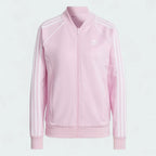 Adidas Adicolor Classics Superstar Track Jacket in orchid fusion pink, front view showing full zip, stand-up collar, white 3-Stripes on sleeves, and embroidered Trefoil logo.