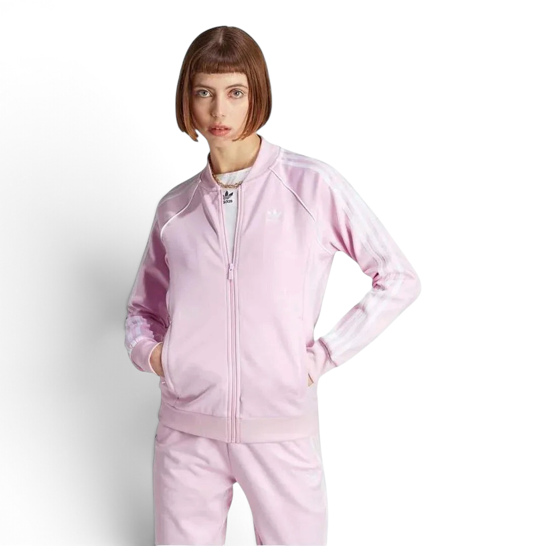 Adidas Adicolor Classics Superstar Track Jacket in orchid fusion pink, front view showing full zip, stand-up collar, white 3-Stripes on sleeves, and embroidered Trefoil logo.
