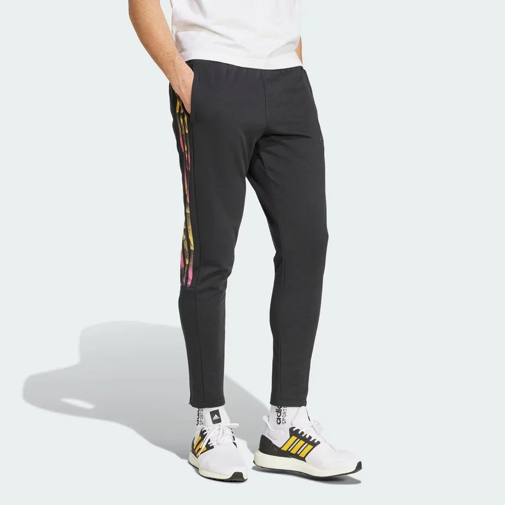 Adidas Tiro Running Track Pants in black, front view showing the tapered leg, elastic drawcord waist, and front zip pockets.
