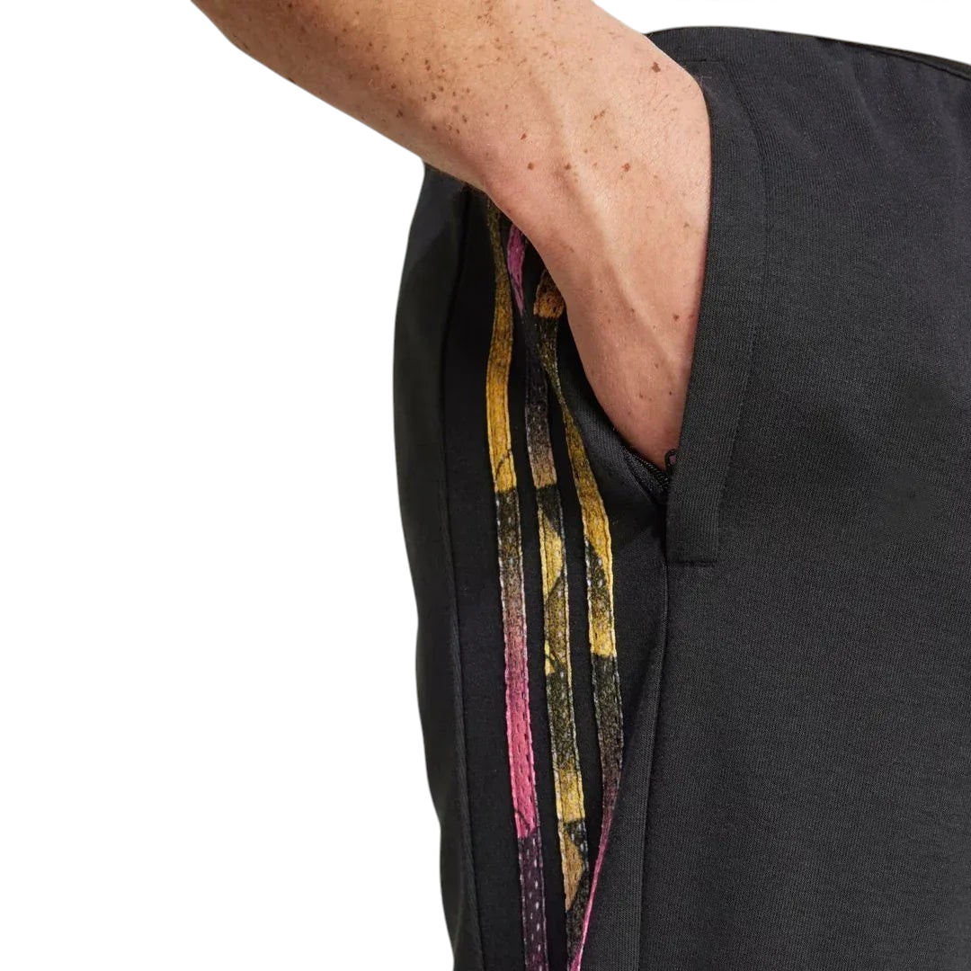 Close-up zoom on the fabric of the Adidas Tiro Running Track Pants in black, showing the colourful stripes