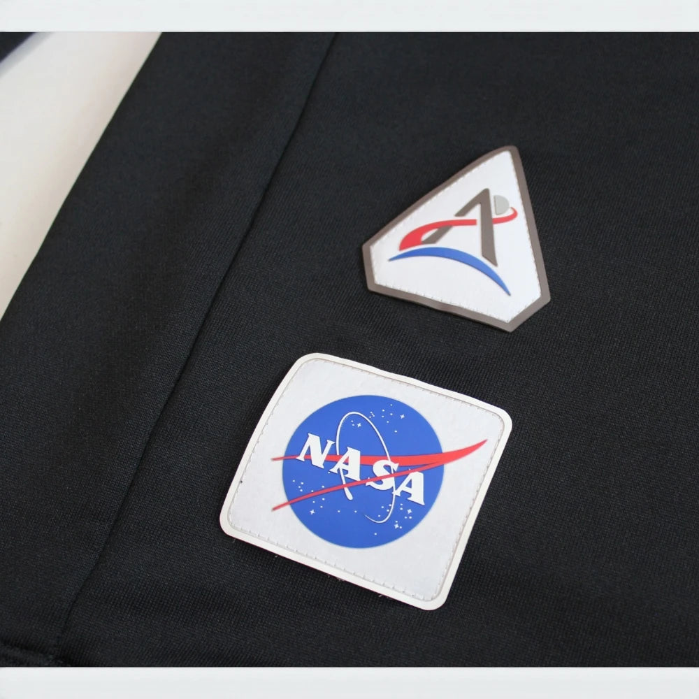 Details the high-definition Artemis mission patch and the precision of the silver print.