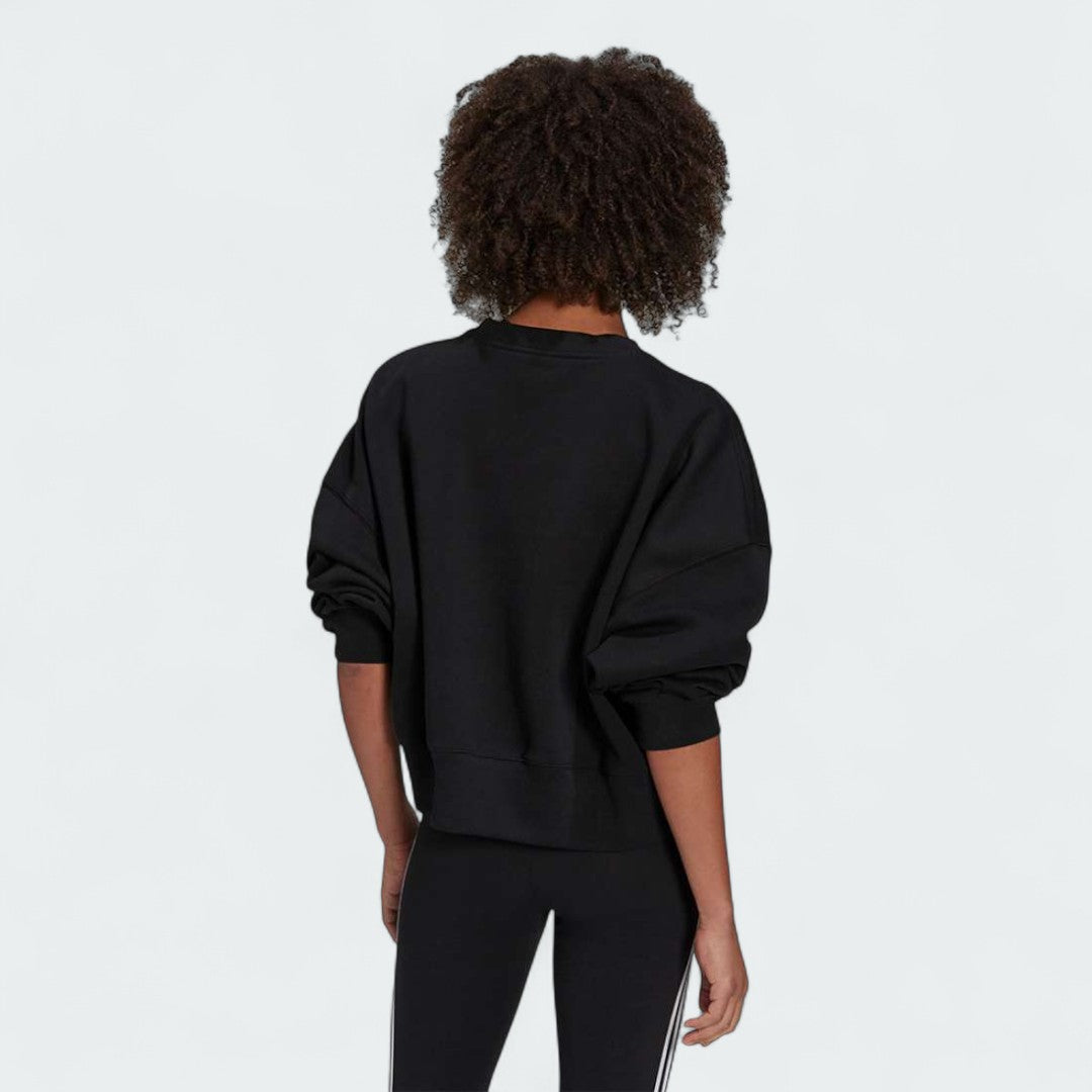 Adidas Adicolor Essentials Fleece Crew Sweatshirt Women's in black, back view showcasing the plain design and the soft fleece texture.