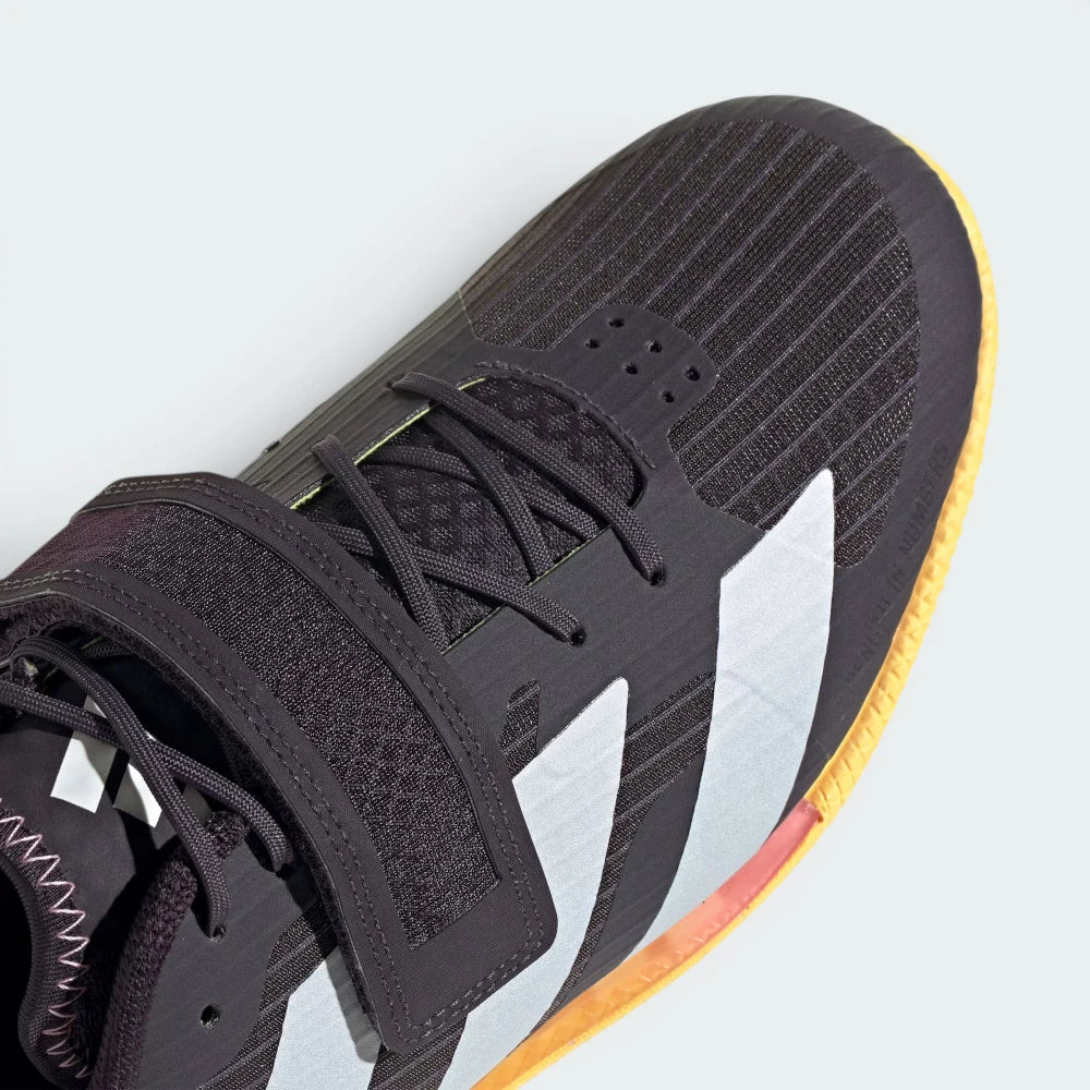 Details the premium double-stitching wrapping the reinforced canvas toe box cap and the high-tension tracking across the main instep strap buckle.