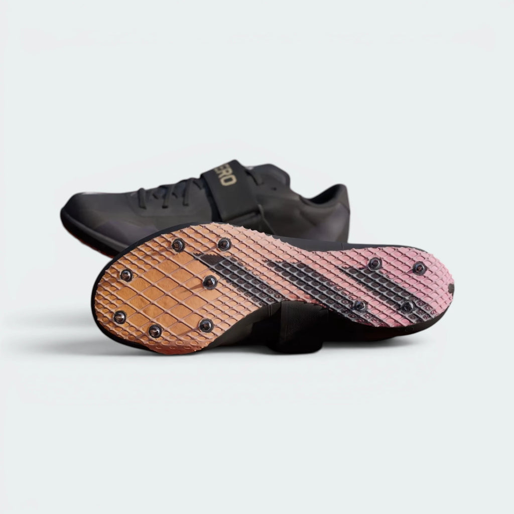 Displays the full-foot technical spike configuration and the rigid plate texture designed for confident high-jump aprons grip.