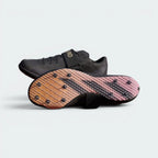 Displays the full-foot technical spike configuration and the rigid plate texture designed for confident high-jump aprons grip.