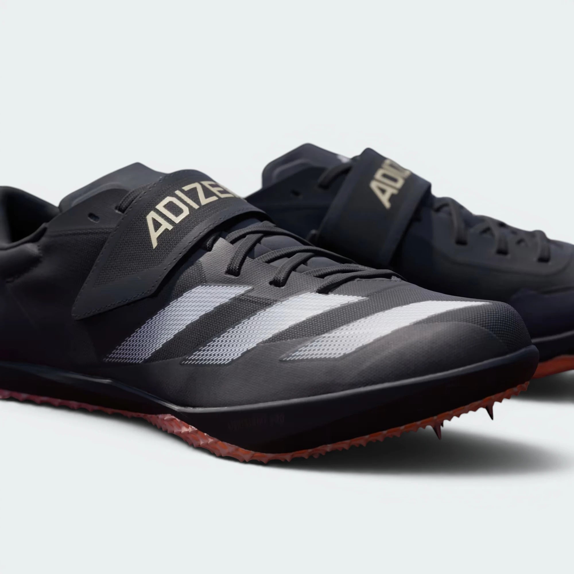 Details the texture of the hook-and-loop material and the precision alignment of the forefoot spikes.