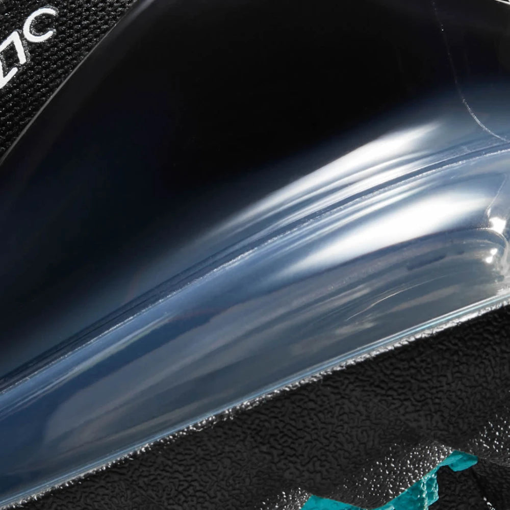 Highlights the "unreal" clean finish where the thick foam cushioning carrier meets the aggressive traction outsole, framing the massive structural cavity of the Max Air heel unit.