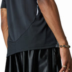 Detailed close-up angle capturing the curved hemline, breathable side panel mesh texturing, and the subtle AEROREADY hem label.
