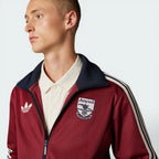 Zoom focusing on the embroided logo and monogram zip