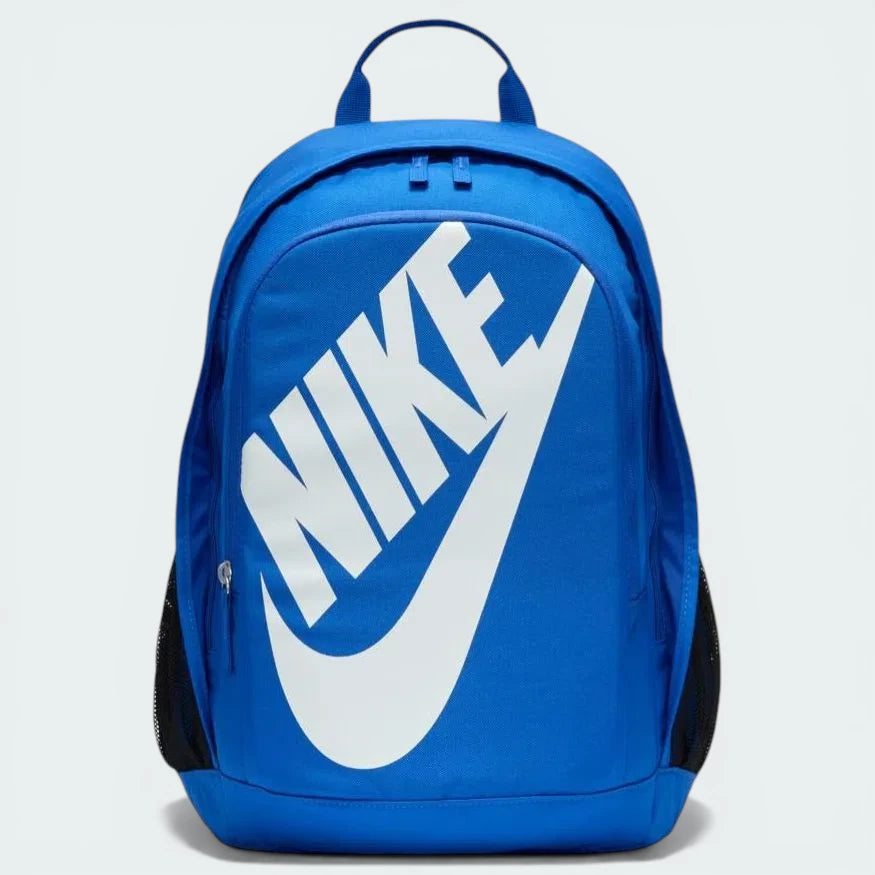 Overhead view of the backpack laid flat, highlighting the dual-zipper configuration and the oversized white Nike logo on the front.