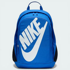 Overhead view of the backpack laid flat, highlighting the dual-zipper configuration and the oversized white Nike logo on the front.