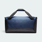 Shows the clean Midnight Navy back panel with heavy-duty black corner reinforcement, the black coated bottom base, and the top grab handles held together by a navy padded grip wrap.