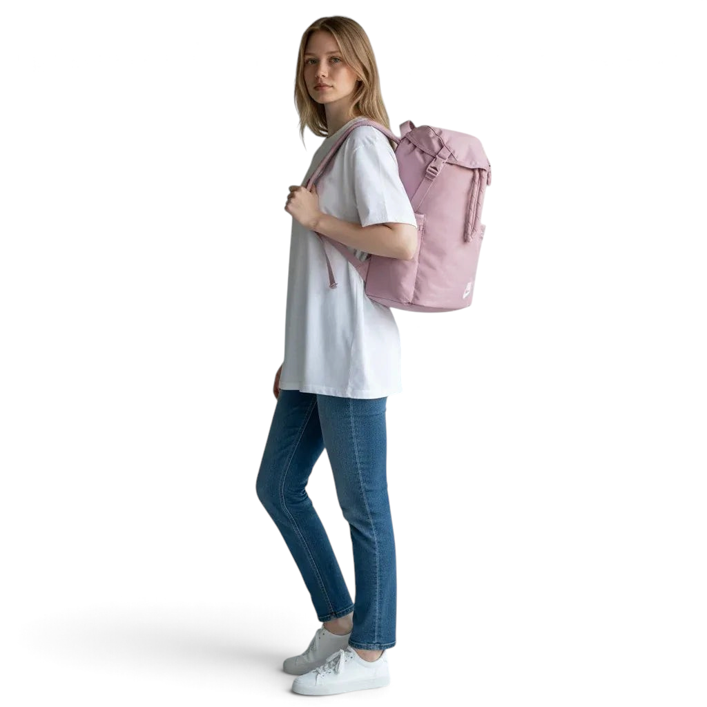 Woman holding a pink backpack against a plain background