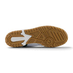 Full-length bottom profile showing the multi-directional non-marking rubber outsole, highlighting the circular forefoot basketball pivot ring, lateral stabiliser channels, segmented flex borders, and embossed central New Balance branding.