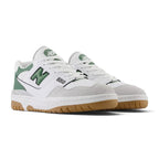 Forward three-quarter angle showcasing both shoes side by side, highlighting the chunky 1989 court stance, layered leather and suede texture depth, puffed branding accents, and clean retro silhouette.
