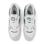 Direct overhead view of both shoes laid flat, showcasing the Brighton Grey suede toe overlay, perforated leather vamp, flat white laces threaded through reinforced eyelets, padded mesh tongue with basketball graphic crest badge, and cushioned comfort sockliner.