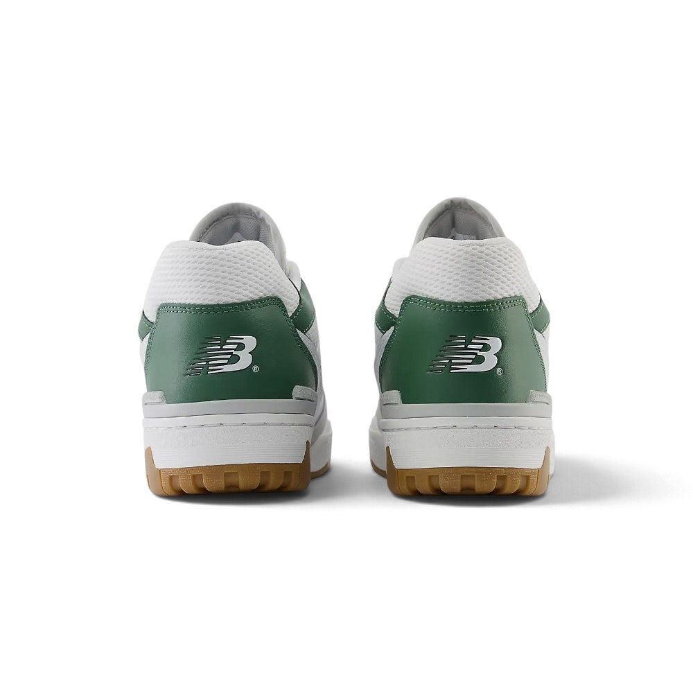 Close-up rear angle focusing on the structured white leather heel counter, Nori green suede and Green collar inserts, embroidered Flying 'NB' logo, and solid rubber cupsole base.