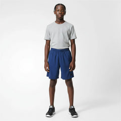 Person wearing a gray t-shirt and blue shorts on a white background