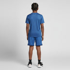 Person wearing a blue athletic outfit on a gray background