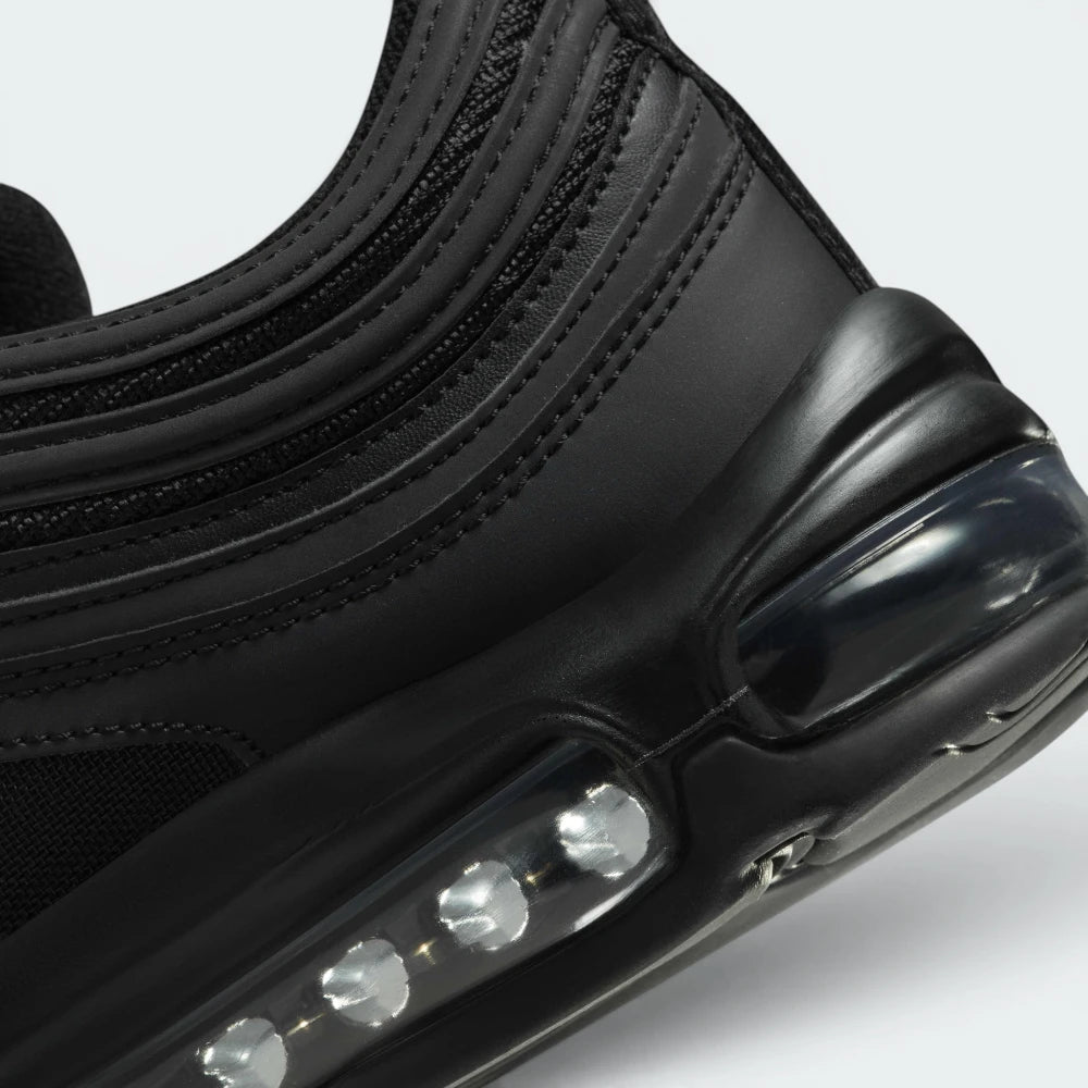 Highlights the "unreal" clean finish where the upper black synthetic mudguard seamlessly bonds onto the top edge of the white cushioning wall.