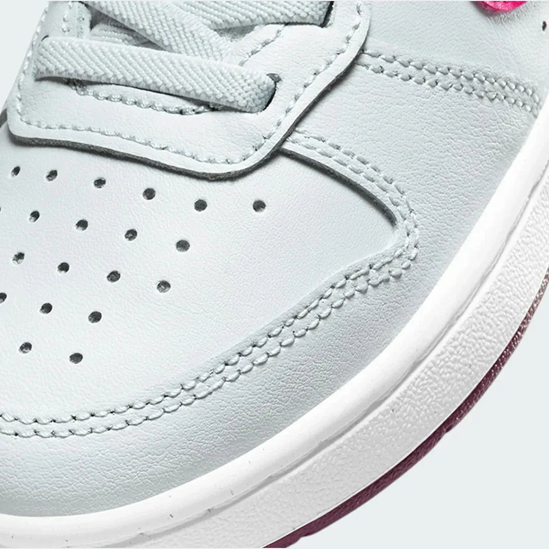 Close-up zoom on the front of the Nike Court Borough Low 2 Girls' trainers, showing the perforated toe box, lacing system, and texture of the upper materials.