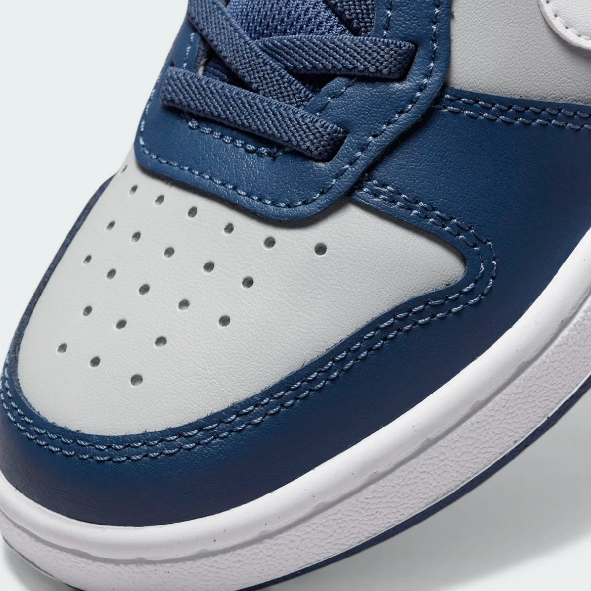 A close-up of the premium leather stitching and the classic perforated detailing on the toe.