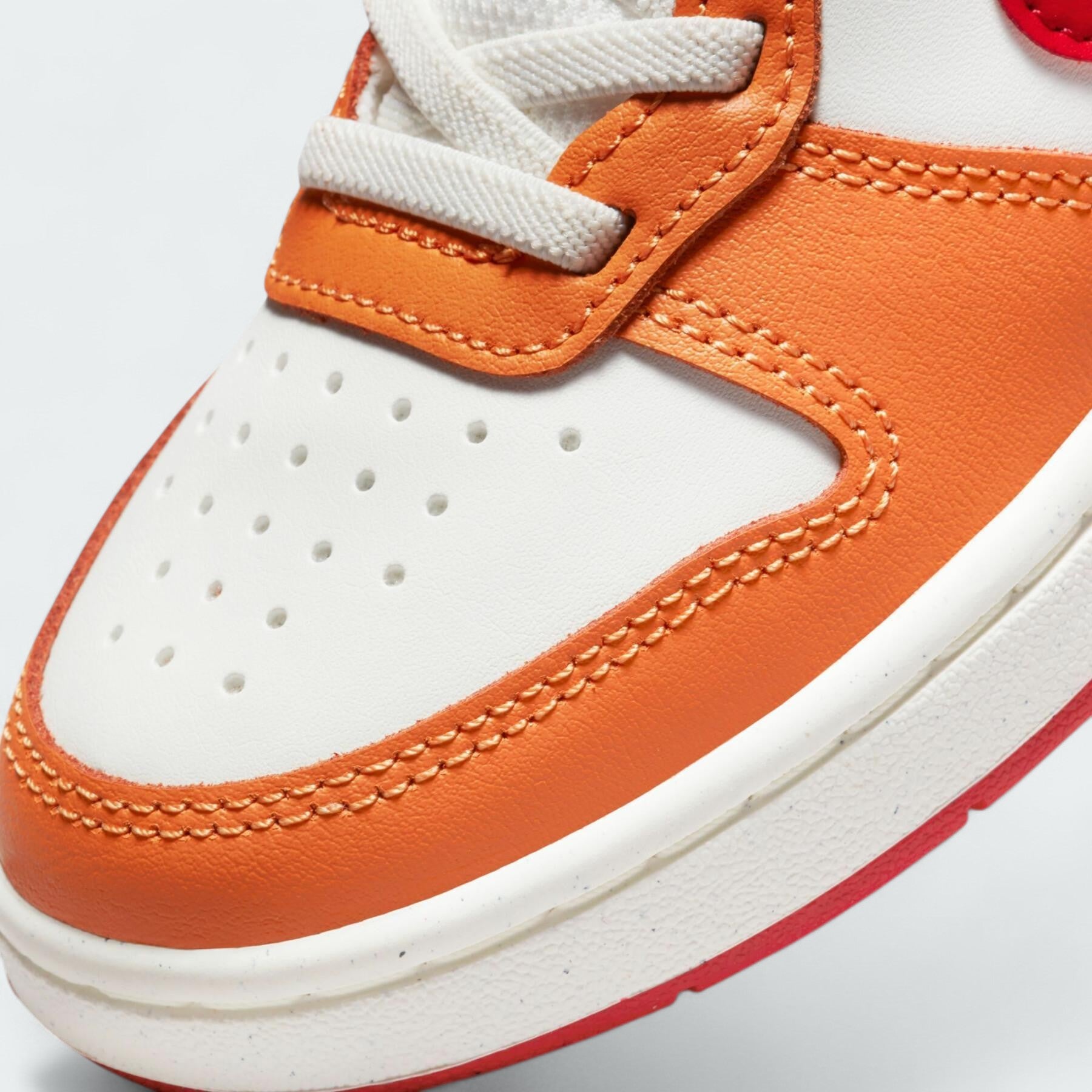 Close-up zoom on the front of the Nike Court Borough Low 2 children's trainers, showing the lacing system (or elastic laces/velcro) and textured upper.