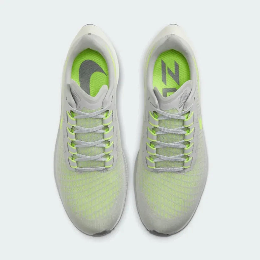 Top-down view of a pair of Nike Air Zoom Pegasus 37 Men's running trainers in grey, highlighting their streamlined silhouette and lace-up closure.