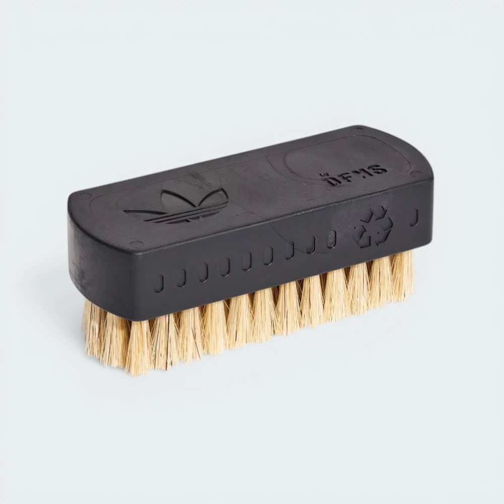 Side profile of the Blue Bird Adidas cleaning brush, highlighting the ergonomic white handle and the dense blue bristles.