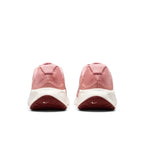 Focuses on the rear profile, displaying the visible external Achilles heel puffs in Red Stardust, supportive heel construction, and the wide flared base of the white foam midsole.