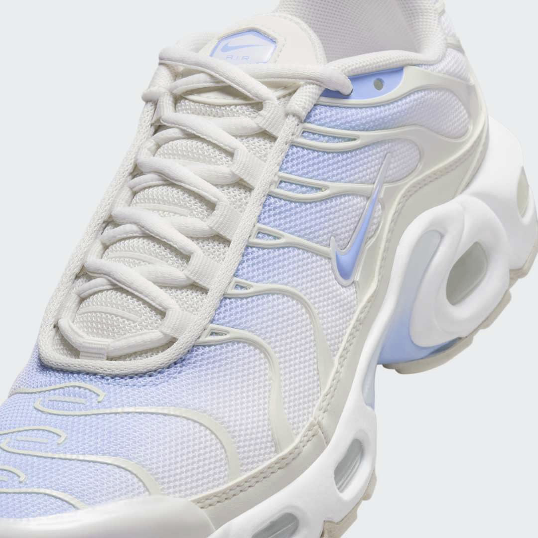 Close-up zoom on the front of the Nike Air Max Plus Juniors' Girls' trainers, showing the mesh toe box, lacing system, and intricate wavy overlays.