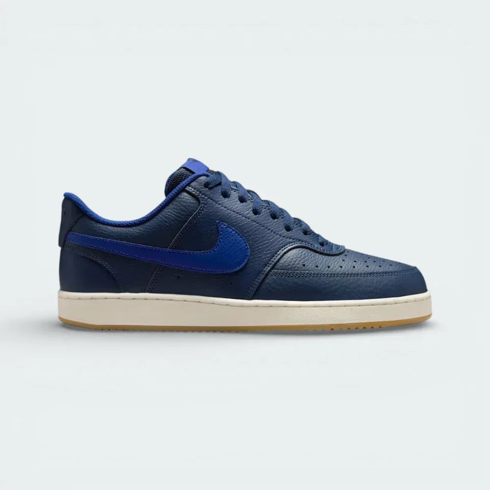 Side profile of the Nike Court Vision Low in Midnight Navy, showing the tonal leather panels and the clean Deep Royal Blue Swoosh. Main image