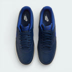 Top-down view of the navy trainers, highlighting the perforated toe box and the matching navy lacing system.