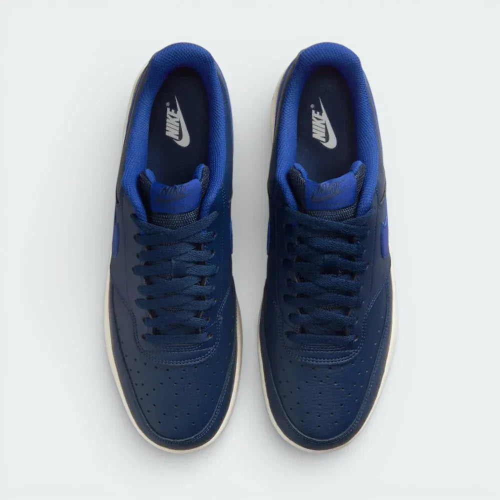 Top-down view of the navy trainers, highlighting the perforated toe box and the matching navy lacing system.