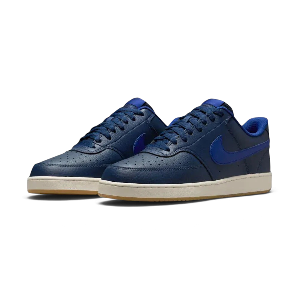 Angled shot of both Nike Court Vision trainers side by side, showcasing the retro 80s silhouette and the rich navy colourway.