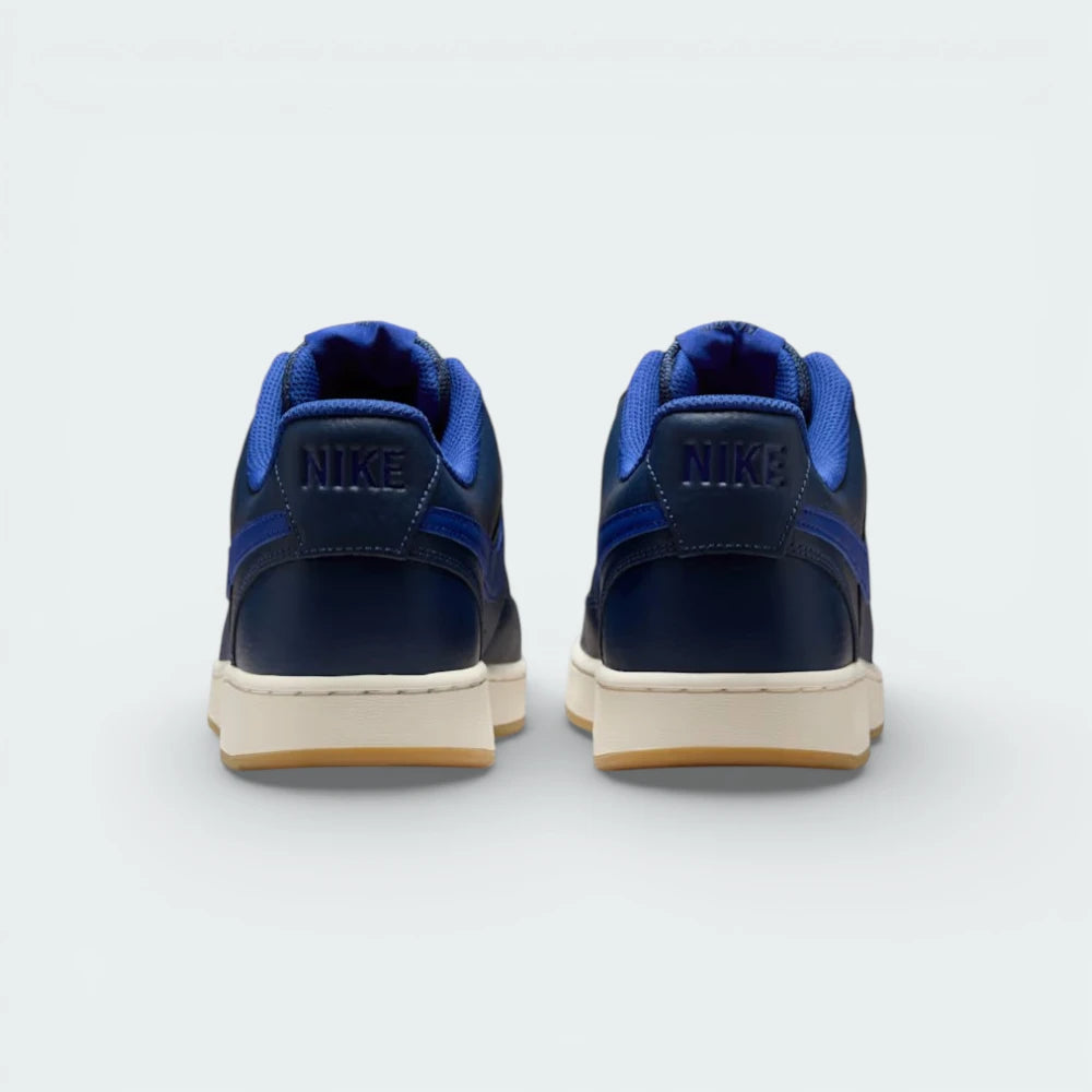 Rear view focusing on the embossed Nike branding on the heel tab and the clean stitching of the leather overlays.