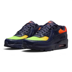 Angled shot of both Nike Air Max 90 trainers side by side, showcasing the layered leather design and the striking contrast of the neon yellow highlights.
