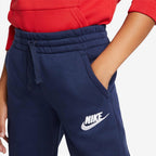 Close-up shot of the elastic waistband, adjustable drawcord, and pocket opening detailing the white Nike embroidery.