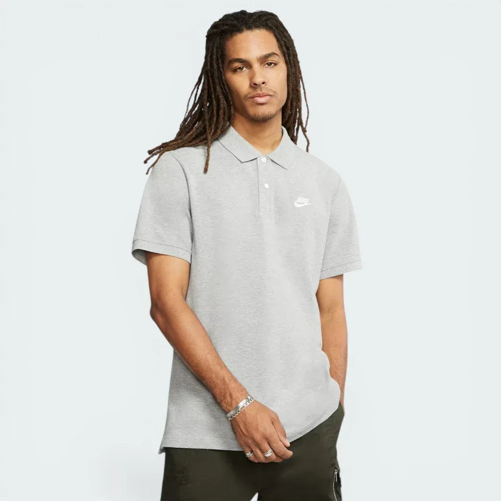 Main profile of the Dark Grey Heather Nike polo, showing the classic standard fit and the side hem vents for added mobility. Main image