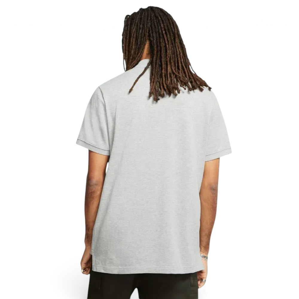 Rear view of the polo, showing the clean, straight-hang hem and the structured fold-over collar.