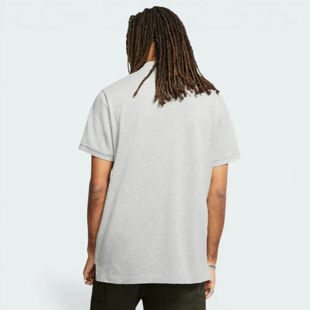 Rear view of the polo, showing the clean, straight-hang hem and the structured fold-over collar.