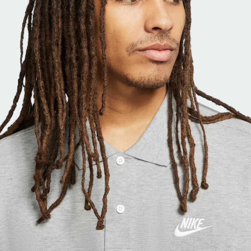 Close-up of the chest area, focusing on the precision of the white embroidered Nike Swoosh and the button detail.