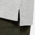 Detailed zoom on the heathered cotton fabric weave and the reinforced stitching at the hem.