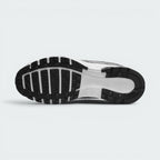Displays the full-length black and white rubber sole, showcasing the classic waffle tread pods interlocked with a central white stability groove stamped with "NIKE" branding.